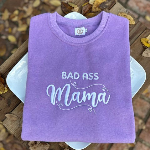 Introducing the ultimate expression of feminine strength - The Bad Ass Mama Lavender Embroidered PPD Crewneck Sweatshirt. A perfect blend of comfort, style, and attitude that will keep you feeling confident all day long! In search of a sweatshirt that not only provides comfort but also makes a statement? Look no further than the Bad Ass Mama Lavender Embroidered PPD Crewneck Sweatshirt.