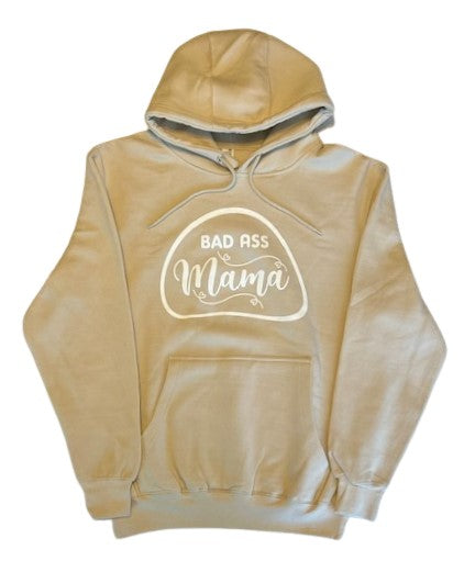 Release your Bad Ass Mama side with our cream hoodie, featuring a bold design that's perfect for fierce women. For the fearless and confident women who aren't afraid to show off their attitude, the Bad Ass Mama Cream Hoodie is a must-have wardrobe essential. The high-quality direct-to-garment design showcases bold font letters spelling out "Bad Ass Mama" against a cream-colored background that will make you stand out from the crowd.