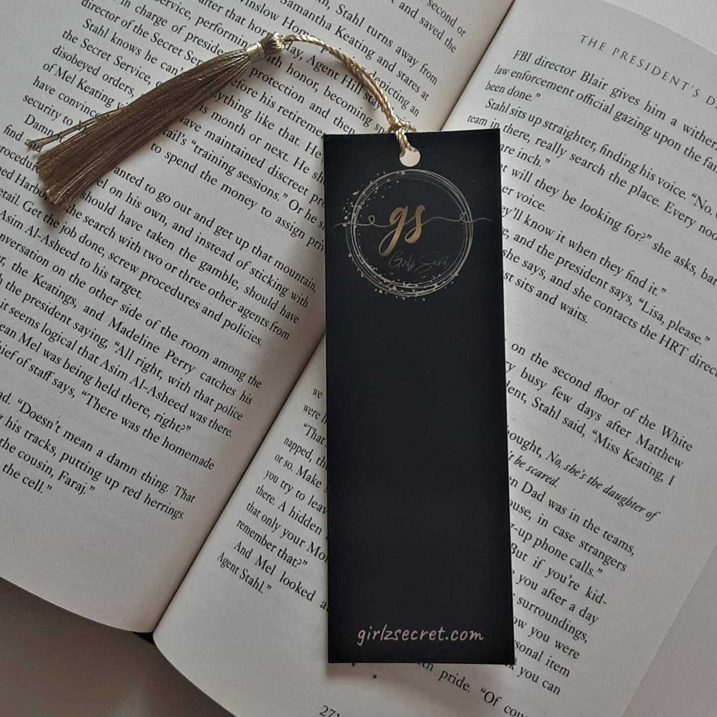 Our Girlz Secret bookmark with its shiny gold tassel is a lovely way to keep your place in a book or journal.  As a bookworm myself, I think that we need bookmarks in our lives in order to pause for a moment, reflect, and then forge on, which is so important when experiencing PPD.  DETAILS  2-inch x 6-inch bookmark. Black with our Girlz Secret logo in gold. Shiny gold tassel.